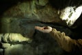 Drop from the ceiling of the cave falls on the person`s hand