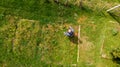 Drop down view of a person mowing lawn. Royalty Free Stock Photo