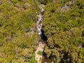 Drop down view of river runing through forest. Royalty Free Stock Photo