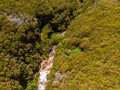Drop down view of river runing through forest. Royalty Free Stock Photo