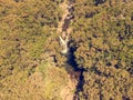 Drop down view of river runing through forest. Royalty Free Stock Photo