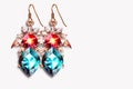 Drop earrings with colored crystals on white background. Generative AI Royalty Free Stock Photo