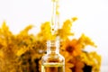 Drop falling from dropper of essential oil, aromatherapy essence, or medicinal liquid Royalty Free Stock Photo