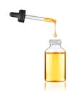 Drop falls from a pipette into a cosmetic bottle Royalty Free Stock Photo