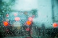 Drop on glass at twilight time while raining.View side out the car.Rain drops on window with road light bokeh,