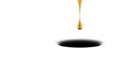 A drop of gold falls into the shadow on a white background. Space for text. Royalty Free Stock Photo