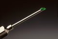 Drop of green liquid at the tip of a hypodermic needle Royalty Free Stock Photo