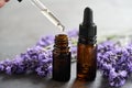 A drop of lavender essential oil falling into a brown bottle Royalty Free Stock Photo