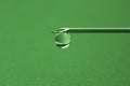 Drop of liquid hangs on the tip of a medical injection needle Royalty Free Stock Photo