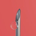 A drop of liquid from the tip of a medical syringe. Macro close up of liquid dripping from injection syringe needle tip. Royalty Free Stock Photo