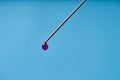 A drop of medicine on the tip of a medical injection needle. Blue background Royalty Free Stock Photo