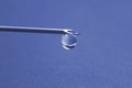 Drop of medicine on the tip of a medical injection needle Royalty Free Stock Photo