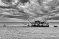 Drop net fishing from one of the famous trebuchets in Marina di Pisa, Tuscany, Italy, under a dramatic sky, in black and white