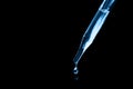 A drop of oil falling from a glass pipette. cosmetology, chemistry, perfumery. macro photo close up. subject photo. Fresh classic Royalty Free Stock Photo