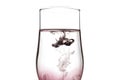 A drop of red and black liquid was just poured into a clear wineglass Royalty Free Stock Photo