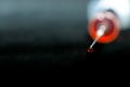 A drop of red medicine in focus coming out of the syringe needle . Royalty Free Stock Photo