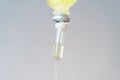 Drop of Saline Solution,IV drip chamber, IV tubing hanging on a metal pole in the room Royalty Free Stock Photo