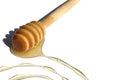 A wooden ladle with spilled honey lies on a white background. Royalty Free Stock Photo