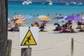 Drop warning sign , falling of the edge yellow triangle warning sign on the beach