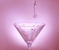 Drop of water falling in martini glass Royalty Free Stock Photo