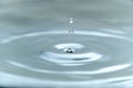 A drop of water hovering in the air before hitting a water surface, which will cause a beautiful splash, close-up photo Royalty Free Stock Photo