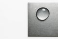 A drop of water on a metal surface. Space for text. Royalty Free Stock Photo