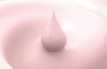 Droplet of pink milk on pink background