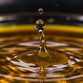 A droplet rises from the surface of a golden liquid, creating ripples. The scene Royalty Free Stock Photo