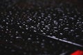 Droplets on the black roof of the car detail