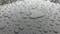 Droplets scatter across a smooth dark surface creating a textured Royalty Free Stock Photo