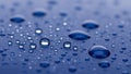 Droplets scattered across a smooth blue surface create a striking Royalty Free Stock Photo