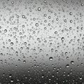 Droplets of water cover a smooth, reflective surface, creating a textured pattern. The Royalty Free Stock Photo