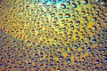 Droplets of Water over a Yellowish Gradient Reflective Surface Royalty Free Stock Photo