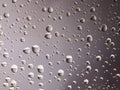 Droplets of water on a warm grey background