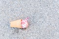 Dropped ice cream cup on the ground asphalt pavement and melted from the heat view from above Royalty Free Stock Photo