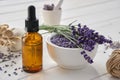 Dropper bottle of essential lavender oil, mortar of dry lavender flowers and sachets on white table Royalty Free Stock Photo
