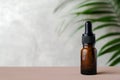 Dropper bottle mockup. Bottle of dark amber glass with essential oil and tropical leaf. Natural organic cosmetic, aromatherapy Royalty Free Stock Photo