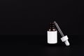 Dropper brown bottle. Cosmetic serum glass pipette isolated on black background. Essential oil eye drop mockup. Clear medicine Royalty Free Stock Photo