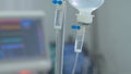 Dropper, drip with medical monitor in ICU. Modern edical equipment in intensive care unit, reanimation.