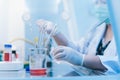 dropper pipette in beaker and scientist using dropper pipette transfer sample in Biosafety cabinet on background. Royalty Free Stock Photo