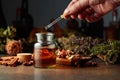 Dropping essential herbal tincture into a small glass bottle Royalty Free Stock Photo