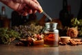 Dropping essential herbal tincture into a small glass bottle Royalty Free Stock Photo