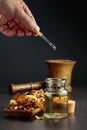 Dropping essential oil or herbal tincture into a small bottle Royalty Free Stock Photo