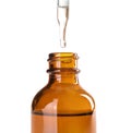 Dropping herbal essential oil into bottle Royalty Free Stock Photo