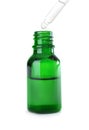 Dropping herbal essential oil into bottle isolated Royalty Free Stock Photo