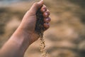 Dropping sand from hand of woman