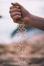 Dropping sand from hand of woman