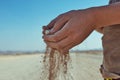 Dropping sand through young kid hands