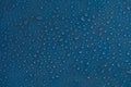 Drops abstract texture. Wet water on blue glass background. Bubble pattern. Royalty Free Stock Photo