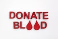 Drops blood donation concept. Text donate blood with red drops on white background